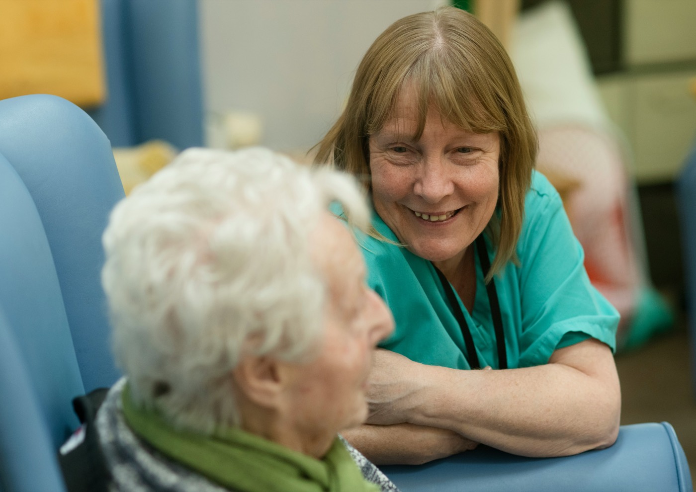 A carer sitting with a resident