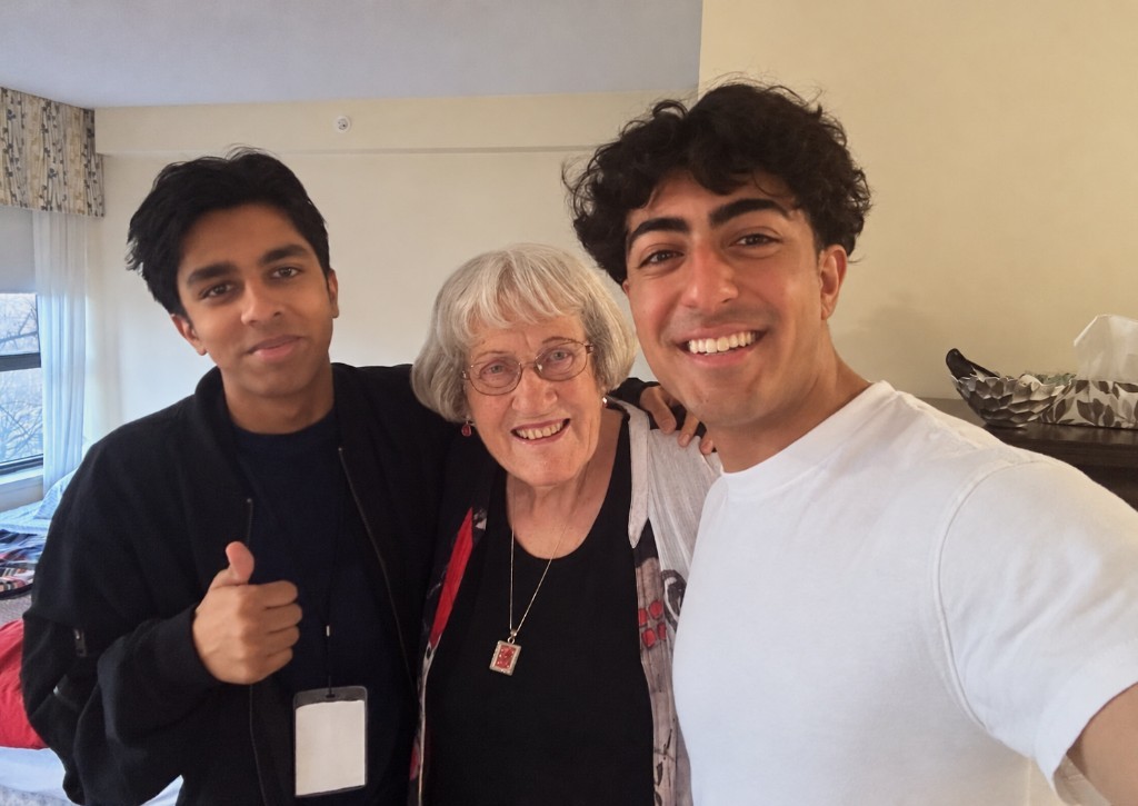 Ascenix co-founders Rishi, on the left, and Ayaan, on the right, with a resident at the retirement home where they lived